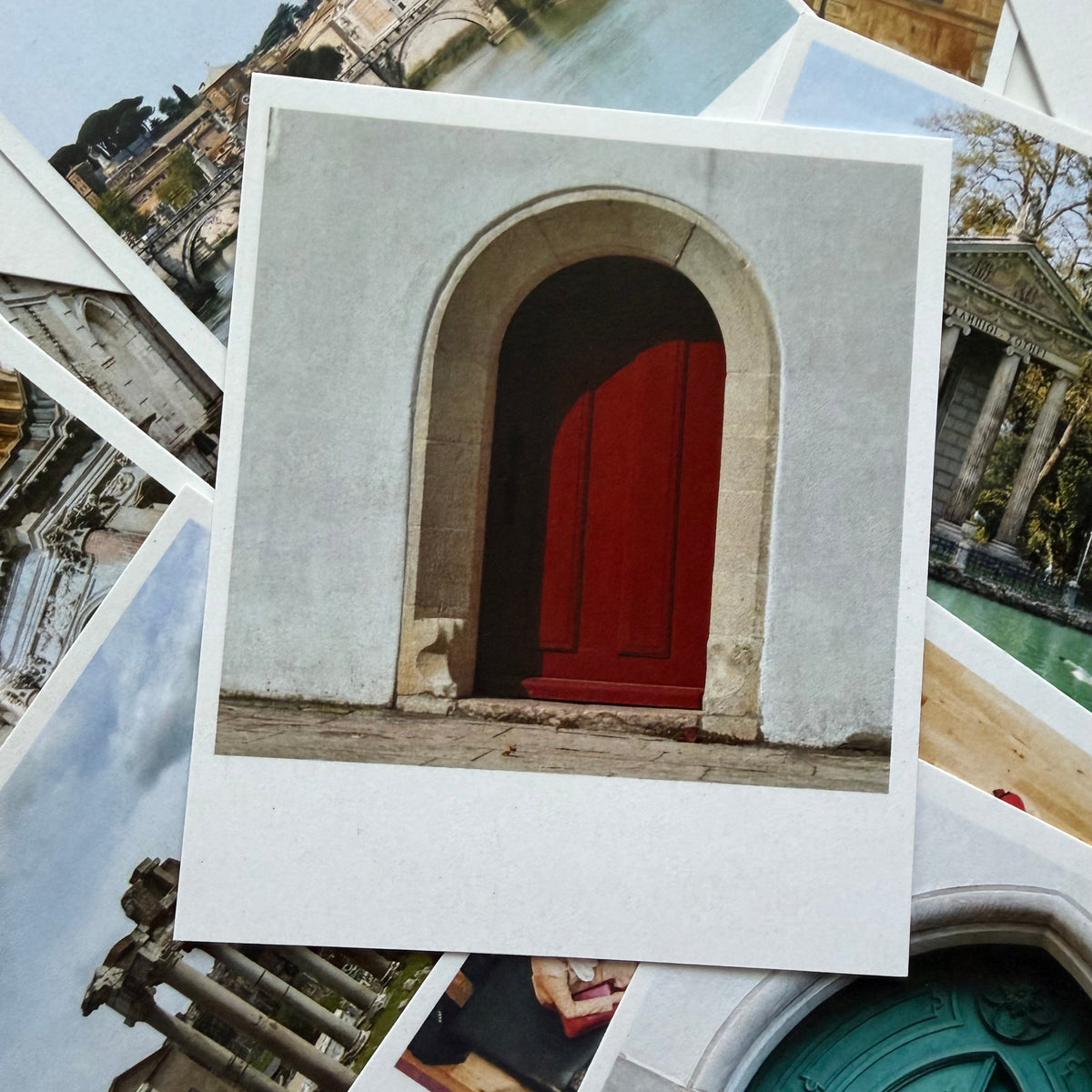 Collection of postcards with architectural scenes, including a red door.