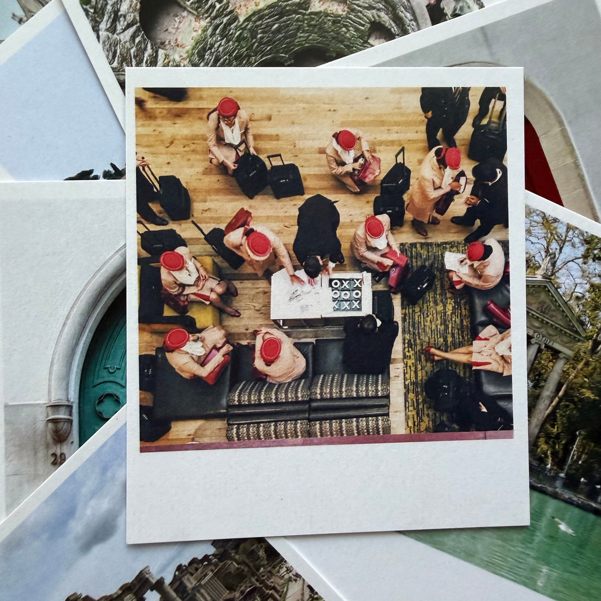 Collage of people in formal attire with red hats around a table, overlaid on nature-themed images.