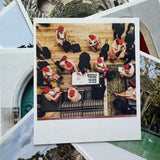 Collage of people in formal attire with red hats around a table, overlaid on nature-themed images.