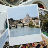 Stack of postcards with images of a cathedral and people.